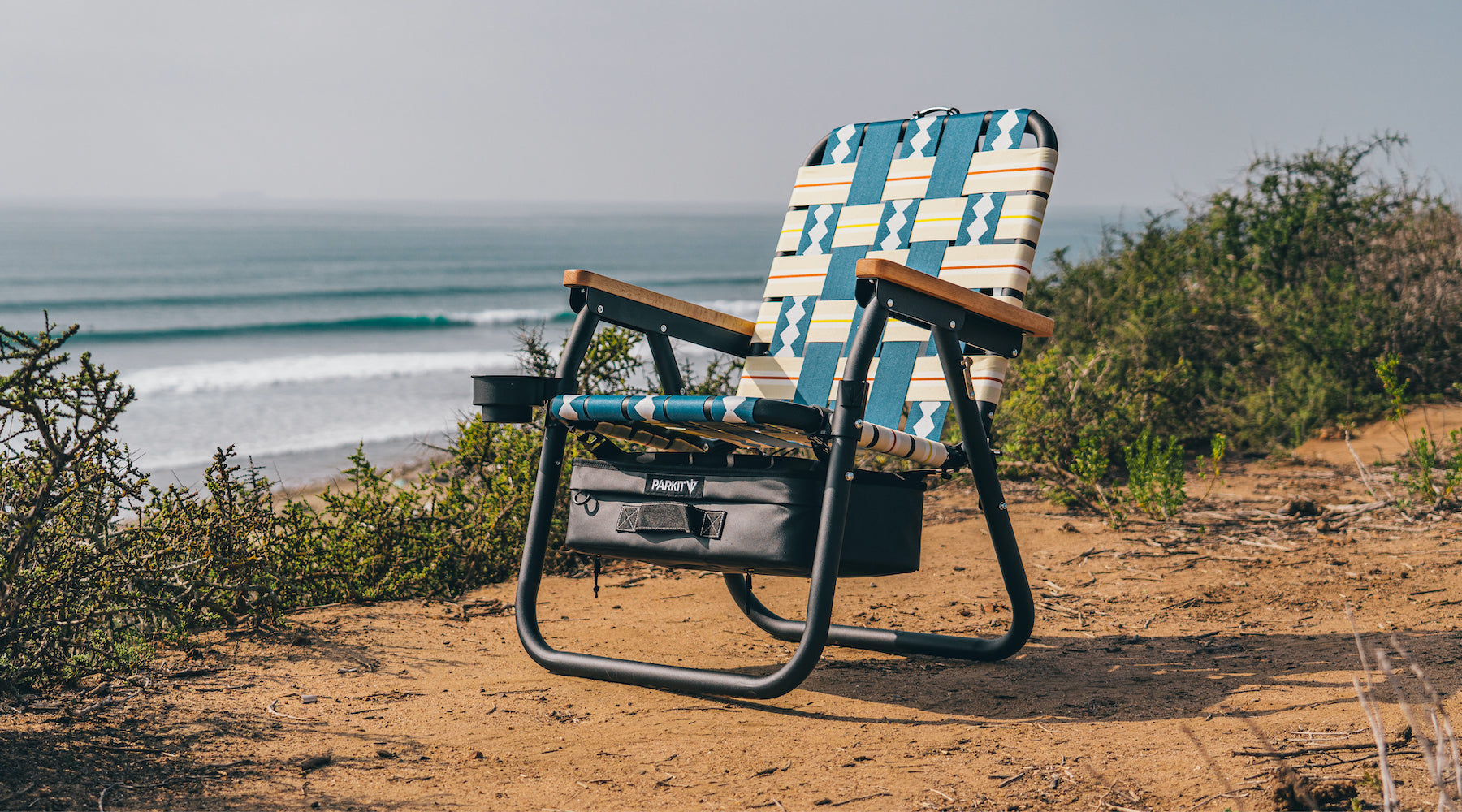 The Voyager Chair in Classic Blue sitting on the cliff above lower trestles in southern California