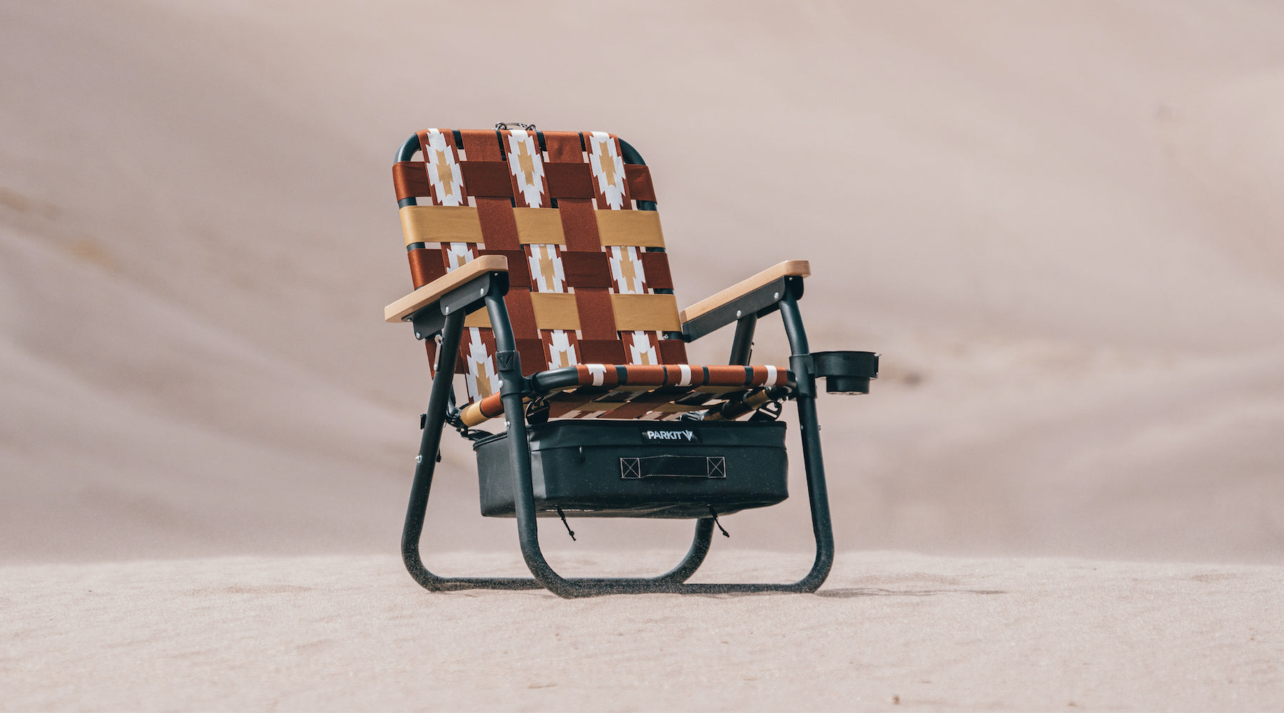 Voyager Chair In Calico sitting on the sand at the great sand dune national park in Colorado.