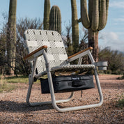 a single camp chair next to saguaro trees