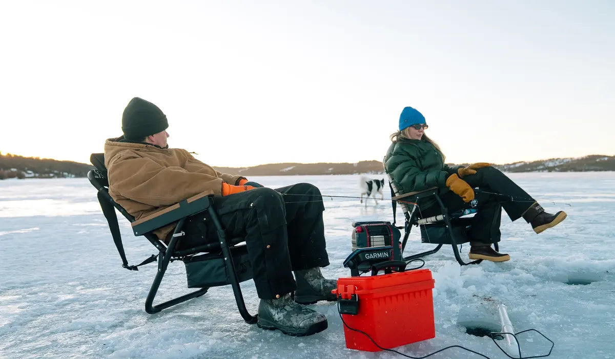 Alaska camping trip overlooking the Alaska Range at sunset with chairs on a frozen lake