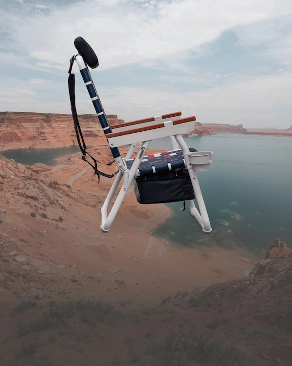 Side angle of the Parkit Eclipse Recliner shown in our 'kick back' recline position in our Old Glory American flag inspired color way with Lake Powell layered in the background.