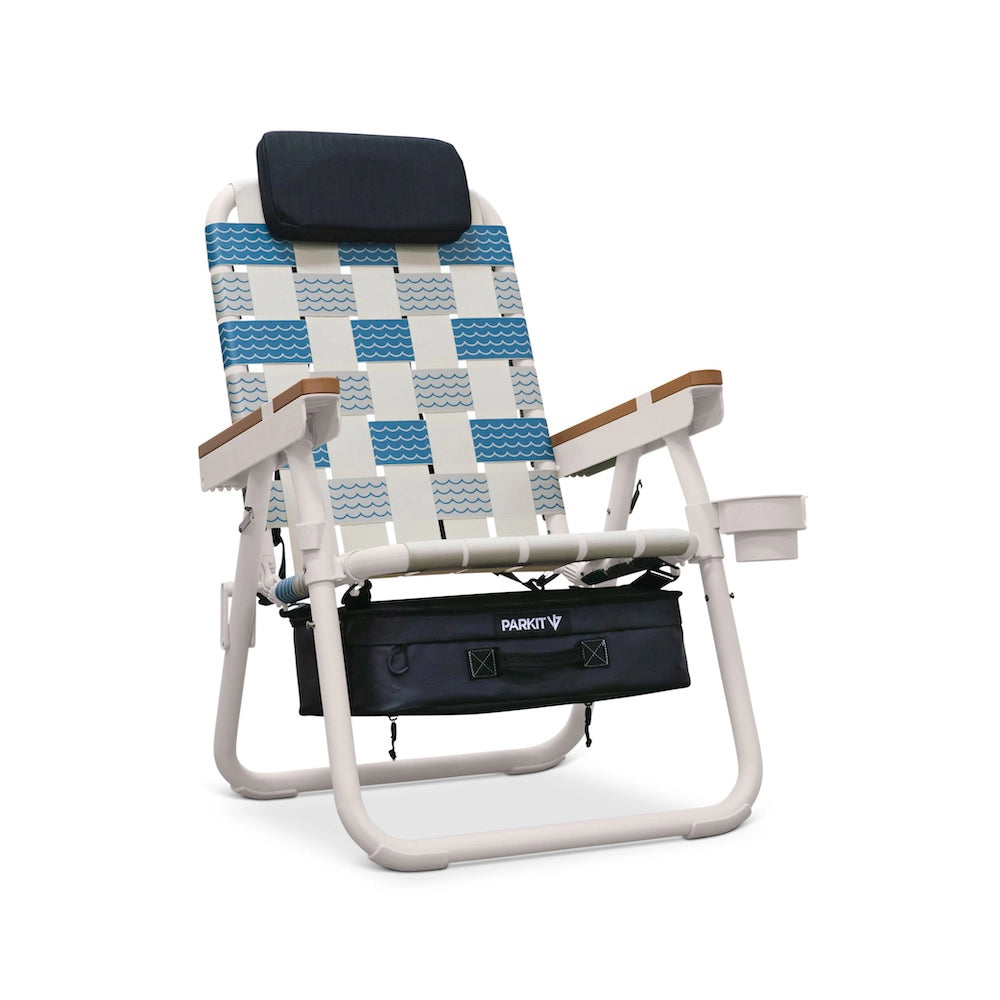 PARKIT Voyager Chair in Olas pattern, featuring blue and white wave-inspired webbing, white powder-coated steel frame, wooden armrests, padded headrest, built-in cooler, cup holder, and backpack straps,premium 3-in-1 outdoor chair built for beach days, adventure, and relaxation.
