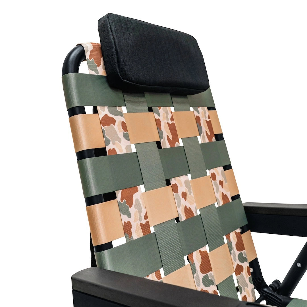 Close-up of the PARKIT × Free Fly Eclipse Recliner in Vintage Camo pattern, showing woven webbing detail and padded headrest. The best folding outdoor chair for dads, moms, campers, and beachgoers, built for comfort, durability, and timeless style with a rugged camo design that fits everywhere from backyard hangs to weekend adventures.