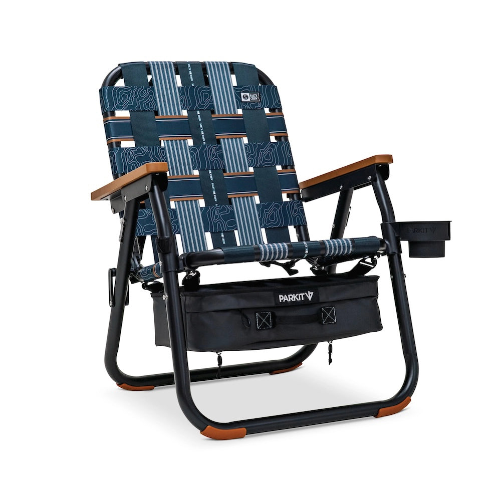 PARKIT x Salty Crew Voyager Chair in limited-edition topo-map pattern, featuring woven webbing, black steel frame, wooden armrests, built-in cooler, cup holder, and backpack straps, rugged 3-in-1 outdoor chair built for surf, fish, and adventure.