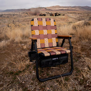 PARKIT Folding chair with a patterned seat in a ranch landscape with mountains and grazing cattle.