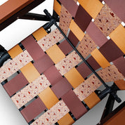 Close-up of a PARKIT woven chair seat with a cowboy and ranch-life inspired patterned design on a white background