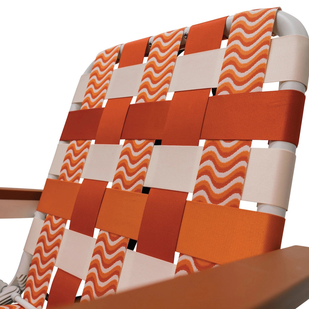 Close-up of a chair with orange and beige woven pattern on a white background