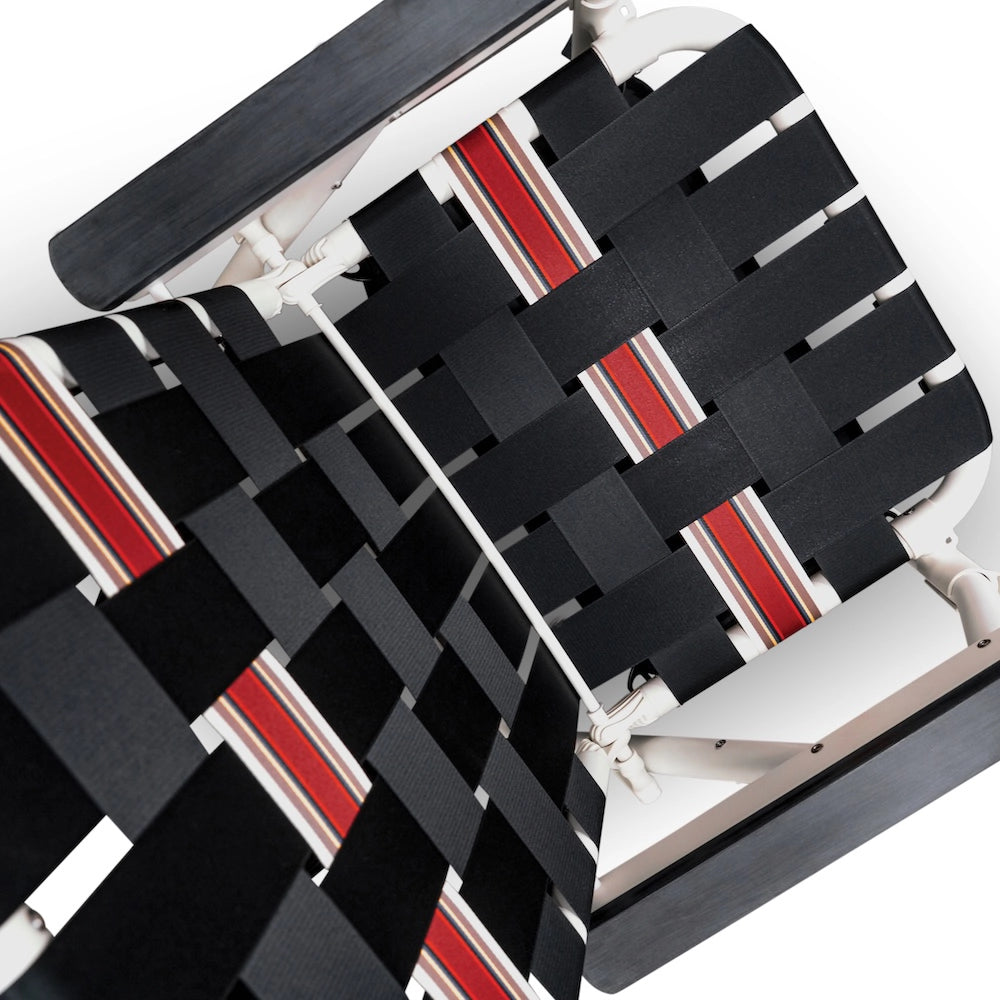 Black and red woven seat cover on a chair with a white background