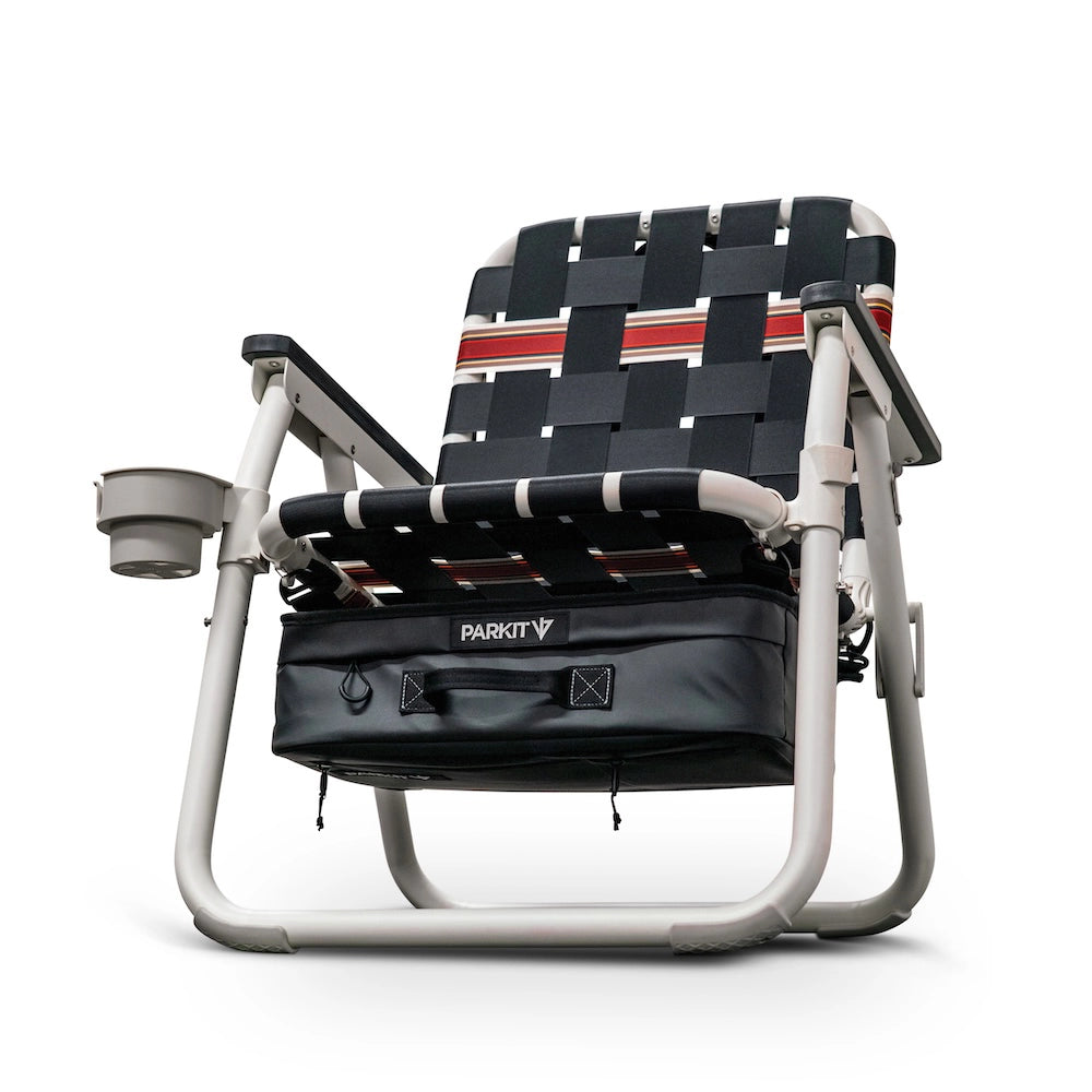 Foldable chair with woven seat and cup holder and cooler on a white background