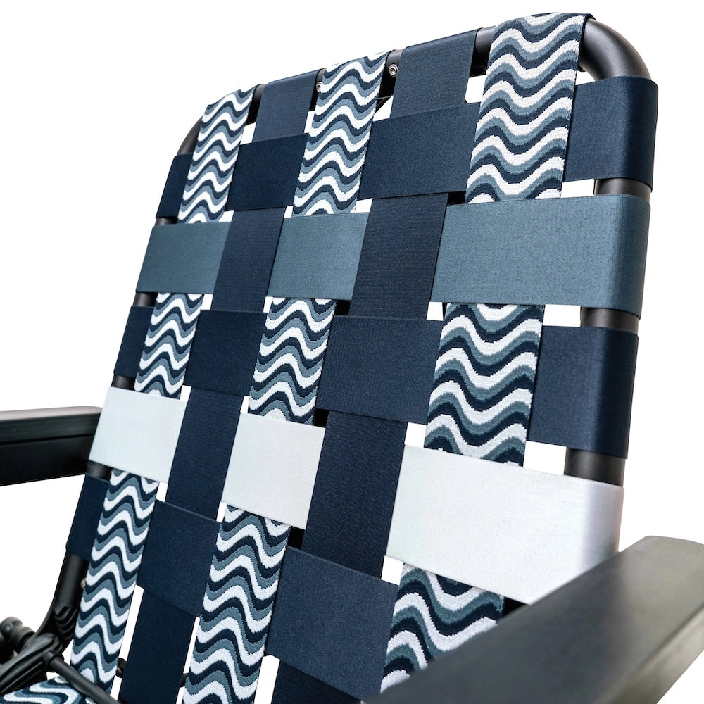 Close-up of a woven seat webbing with a wavy blue and white pattern on a chair, mixed with other ocean blues