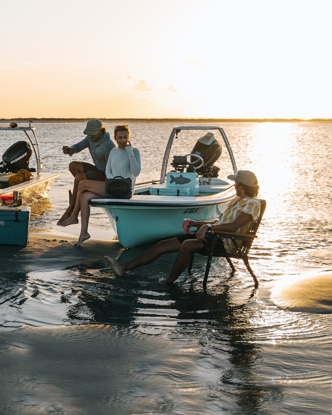 A group of friends sitting in their PARKIT Voyager Outdoor Chairs having a sandbar party in the carolina's at sunset just outside of Charleston.
