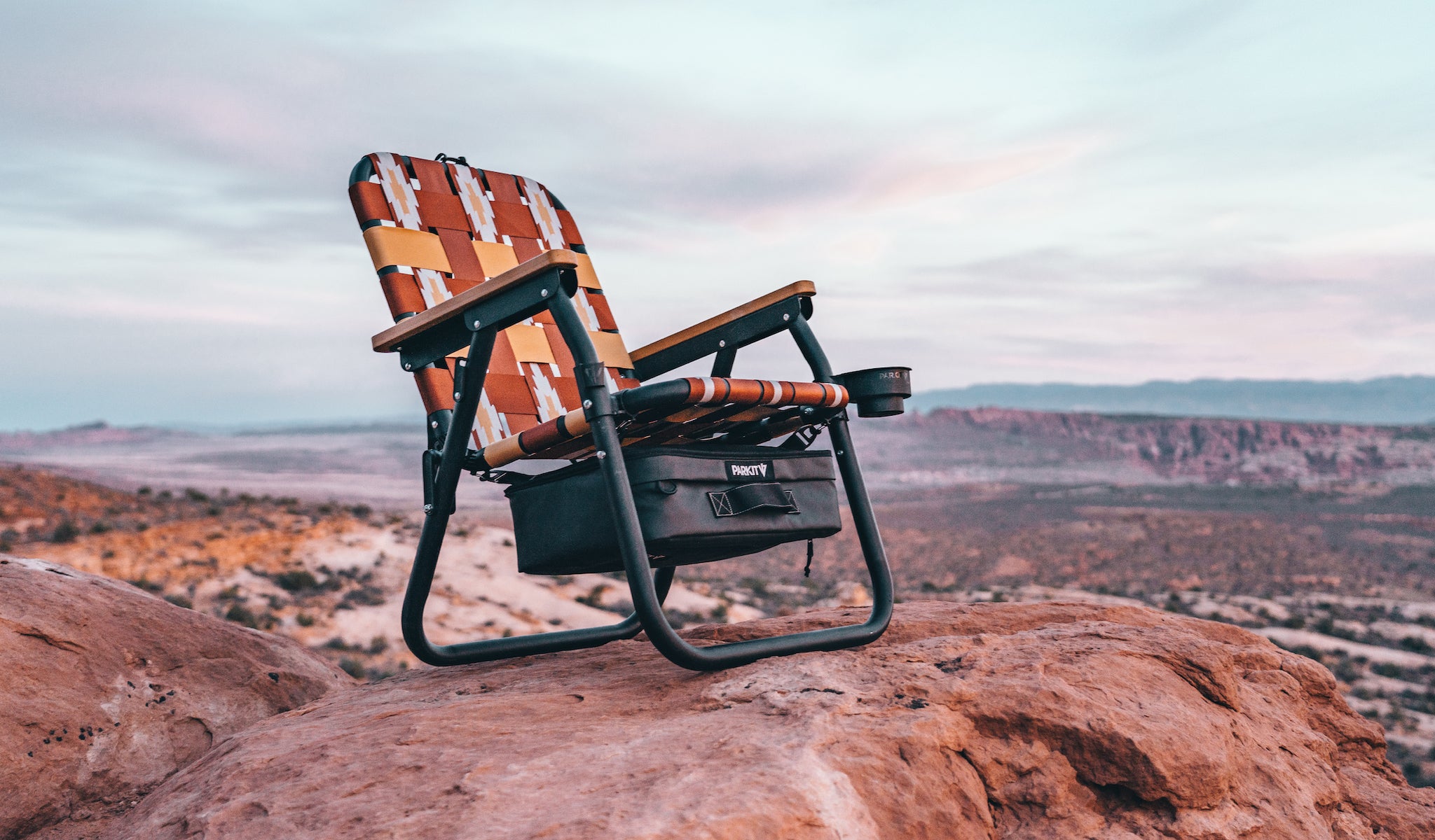 Voyager Chair in Calico by PARKIT on a red rock in Arches National Park as the sunrises