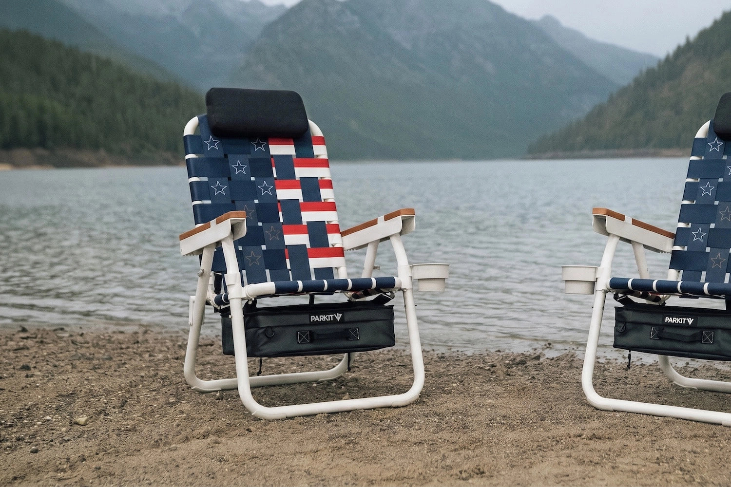 Old Glory Eclipse Recliner chair on the lakeshore in the mountains displayed in a hero orientation with it's inspired American flag design. 